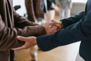 A close-up of two business professionals shaking hands, symbolizing trust and partnership.